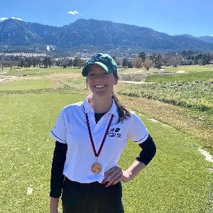 Girls wearing medal with hand on hip